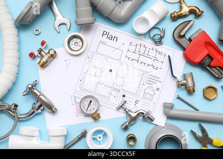 Composition with plumber's items and house plans on blue background Stock Photo