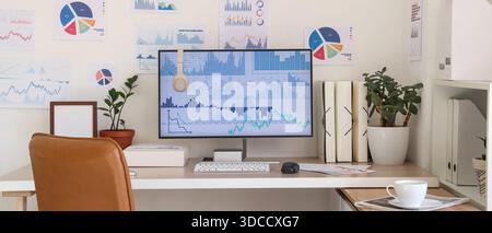 Data scientist's workplace with computer and diagrams in office Stock Photo
