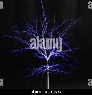 Purple electric sparks from a Tesla coil creating an impressive corona discharge. Stock Photo