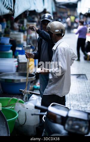 A Vietnamese man wearing a helmet in Hai An, Vietnam 10th November 2019 Stock Photo