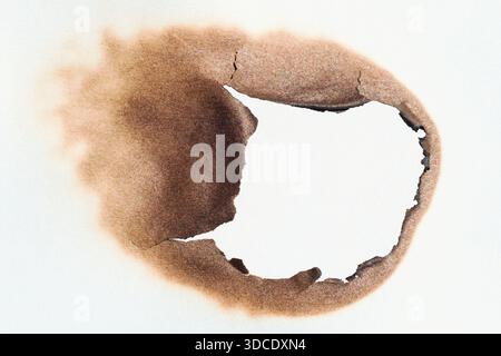 Burned hole in the paper Stock Photo