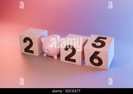 Financial plan for 2026. A small piggy bank standing between wooden blocks displaying the date. Concept for savings, investment, budget planning, and Stock Photo
