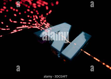 Digital stream of data flowing towards a futuristic, glowing green AI text on a dark background. Concept representing machine learning, neural network Stock Photo