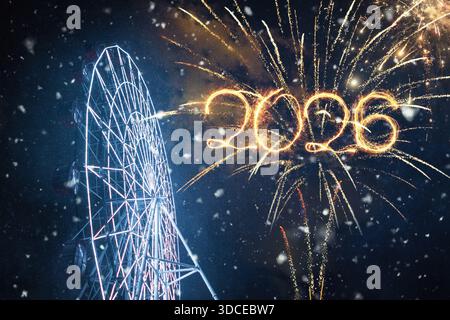 Happy New Year 2026 Celebration. Fireworks display with numbers 2026 written in light against a night sky with snow and a brightly lit Ferris wheel. F Stock Photo