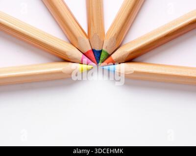 Set of colored pencils making a circle on a white background, ideal for educational or artistic concepts Stock Photo