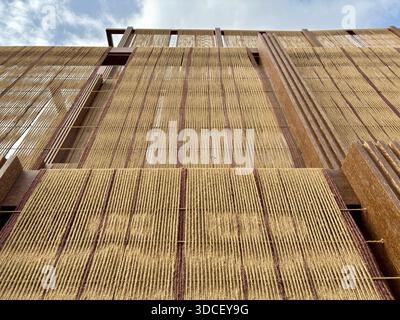 Low-angle shot of a modern building with a woven rope facade Stock Photo