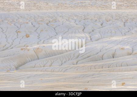 View of bright, sun-baked earth, etched with intricate patterns of erosion, revealing the subtle textures of the arid landscape, Senek, Mangystau Regi Stock Photo