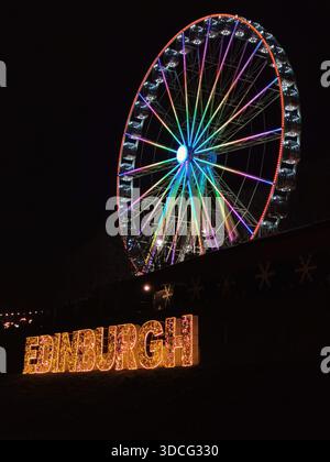 Festive scenes from Edinburgh Christmas Market with glowing stalls, illuminated buildings and a giant lit Edinburgh sign creating a vibrant scene. Stock Photo