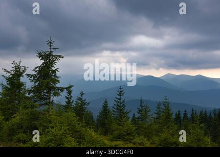 Wonderful summer panorama with mountains. A thunderstorm is coming. Rain Clouds Above Mountains. Location place Carpathian mountains, Ukraine, Europe. Stock Photo