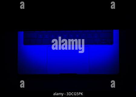 Open Glowing Blue Neon Light Modern Laptop Mockup in three-quarters in black Background, Based on a High-quality Studio shot Stock Photo