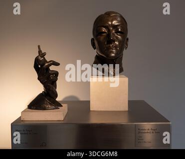 Zaragoza, Spain - 27 May 23: Two bronze sculptures displayed on a pedestal; one is a bust of a person, the other depicts a hand in a dynamic pose Stock Photo