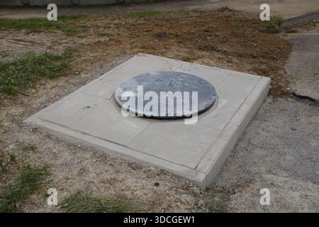 The prefabricated plastic shaft is enclosed with paving slabs Stock Photo