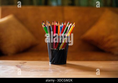 Colored pencils in pen holder with copy space. Stock Photo