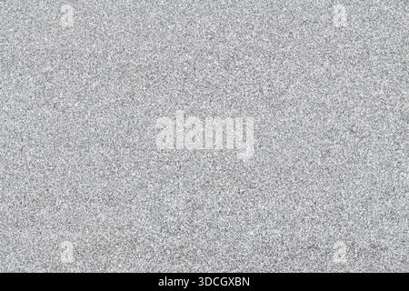 High-resolution close-up of a grey granite stone surface. A natural mineral texture with fine grain, ideal for architectural or industrial backgrounds Stock Photo