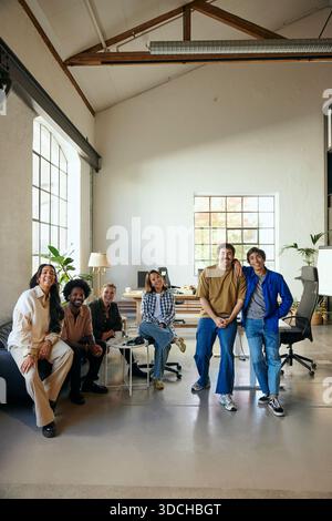 Group of multiracial male and female tech experts looking at camera while posing in new office Stock Photo