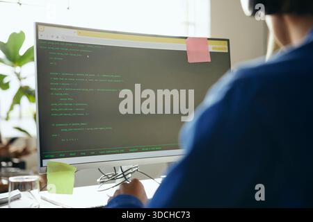 Coding language on desktop PC worked by male programmer in startup office Stock Photo