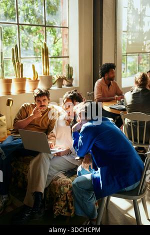 Team of tech experts discussing ideas with each other while working in startup office Stock Photo
