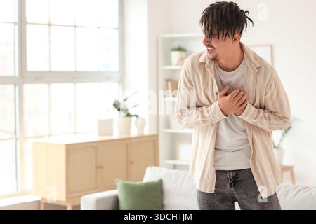 Young man having panic attack at home Stock Photo