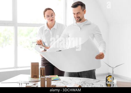 Young architects working with house plan in office Stock Photo