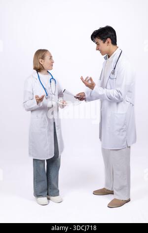 Two doctors in white coats discussing medical results. Stock Photo