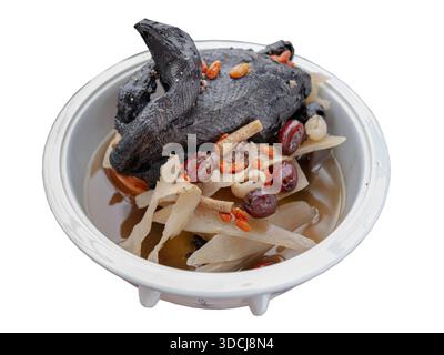 A black chicken soup or silkie chicken soup isolated on White background with clipping path. The dish features the unique silkie chicken, notable for Stock Photo