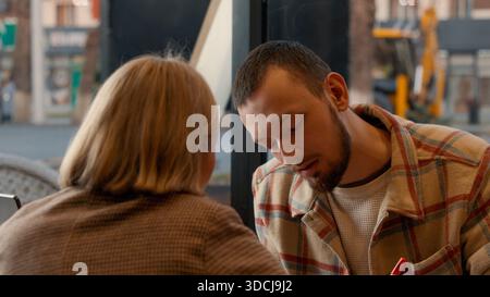 Close up of two students talking and working on a task together. Stock Photo