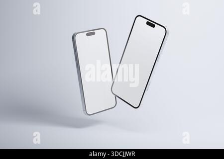 Minimalist mockup with two modern smartphones floating against a light background, featuring blank white screens for app design, user interface presen Stock Photo
