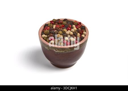 Mix of multi-colored peppercorns in a ceramic bowl isolated on white background. Stock Photo