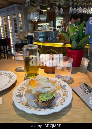 Fried egg and avocado on toast. Stock Photo