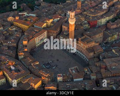 Aerial view of Piazza del Campo bathed in the soft glow of sunset, its ancient stones whispering tales of history, Siena, Tuscany, Italy. Stock Photo