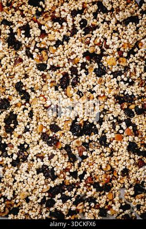 Homemade puffed millet grain granola with dried fruits and nuts as healthy food background. Flat lay, close up Stock Photo