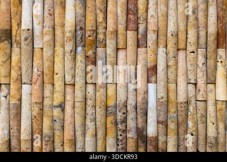 Vertical bamboo canes arranged as a natural textured background, showing warm earth tones, organic pattern and sustainable material Stock Photo