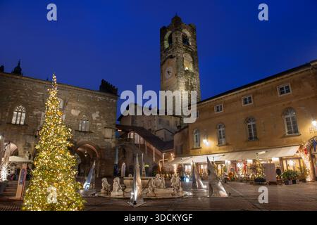 Bergamo's Piazza Vecchia with its bell tower and fountain Stock Photo