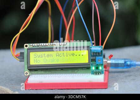 LCD module or liquid crystal display connected to breadboard and sensor module showing some words on the display board controlled by controller Stock Photo