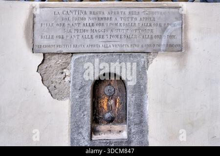 Historic wine window set into plaster wall in Florence, Italy. Stock Photo