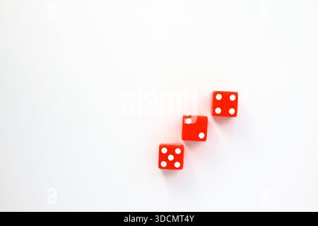 Three red dices on a white background. Top angle photo. Stock Photo