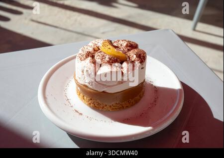 Banoffee pie dessert served on a plate in warm sunlight, highlighting creamy texture and caramel tones in a relaxed Mediterranean setting BirÅ¼ebbuÄa, Malta, 6 DEC 2025. Stock Photo