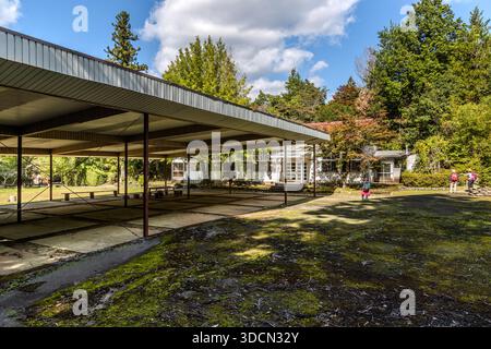 A disused primary school building stands on the Kumano Kodo pilgrimage route at Mizunomi-oji near Tanabe, Wakayama Prefecture, Japan. On the former school ground between Hosshinmon-oji and Kumano Hongū Taisha, the pilgrimage path continues into the forest, with a stamp box, a toilet and Jizō statues with a water source nearby. Stock Photo