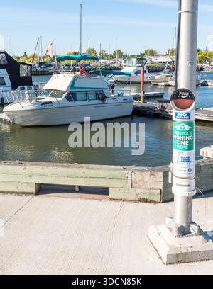 On the Gimli Pier, a bin for used fishing line attached to a metal pole in Gimli, Canada Stock Photo