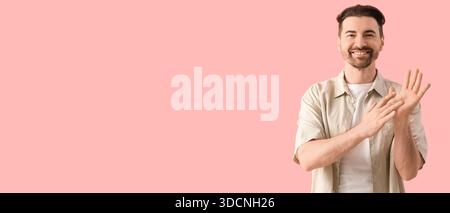 Man using sign language on pink background with space for text Stock Photo