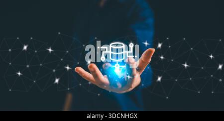 Business professional presenting a glowing database icon within a connected digital network, symbolizing data integration, cloud technology, cybersecu Stock Photo