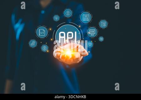 Glowing API interface floating above hand connected digital icon representing application programming interface system integration backend services cl Stock Photo