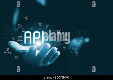 Glowing API concept floating above human hand connected digital icon representing application programming interface system integration data exchange c Stock Photo