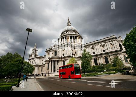 London St Paul's Cathedral and iconic Double Decker Bus over dramatic cloudy sky. Stock Photo