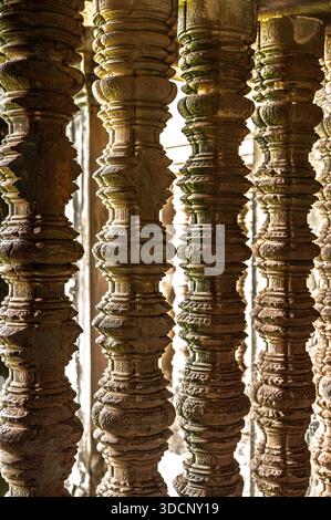 Ancient stone window pillars balusters close up temple architecture detail geometric shape light shadow historic structure archaeology Khmer design de Stock Photo