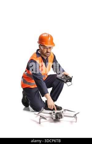 Construction engineer preparing a drone for site inspection isolated on white background Stock Photo