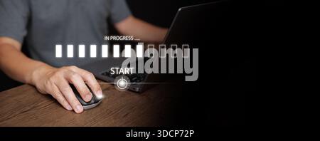 Hand using mouse and laptop with digital start button and progress bar in progress. System loading, workflow execution, task initialization, business Stock Photo