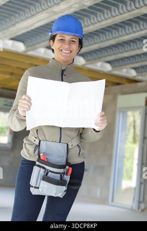 happy builder reading a plan Stock Photo