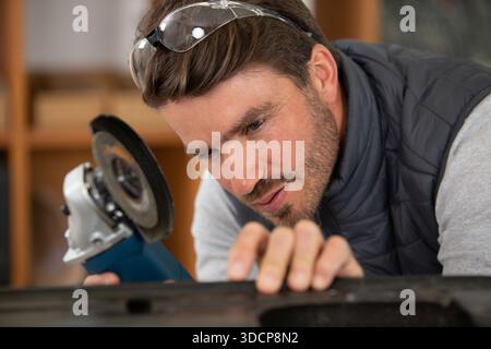 construction worker using handheld circular saw Stock Photo