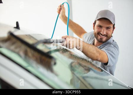 happy window cleaner on white background Stock Photo